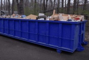 Filled roll off dumpster rental container