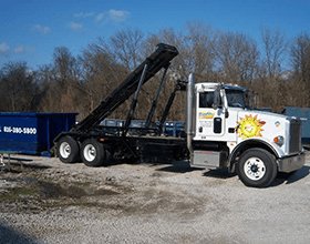 Roll off dumpster rental being dropped off