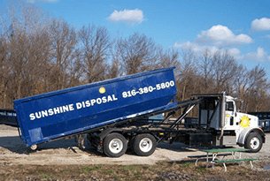 Roll off dumpster rental container being dropped off
